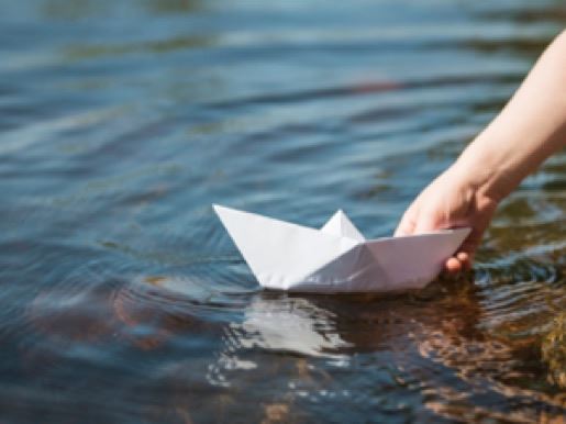 An origami paper boat on the water